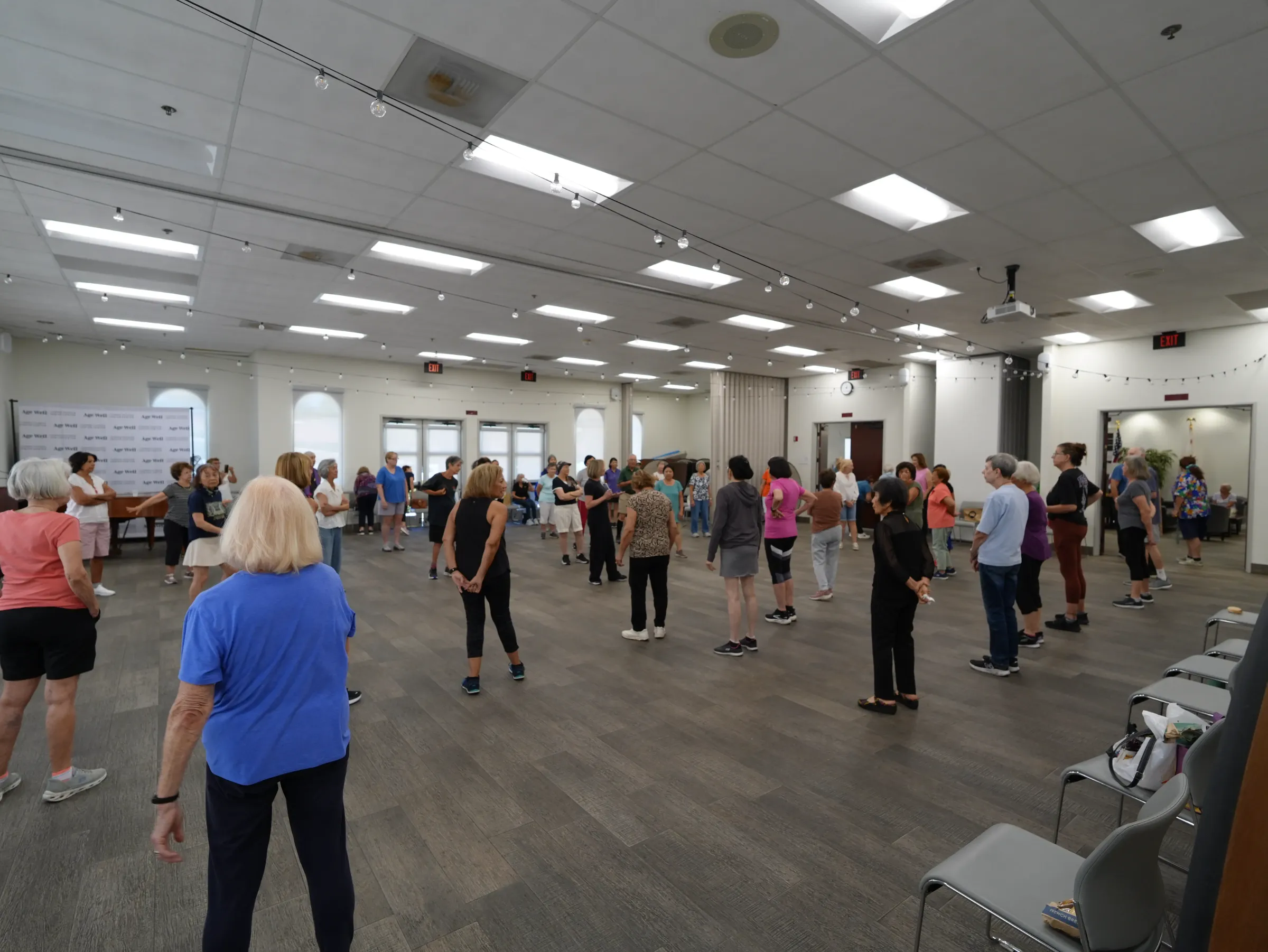 A large Dance for Wellness class gathered at a community center